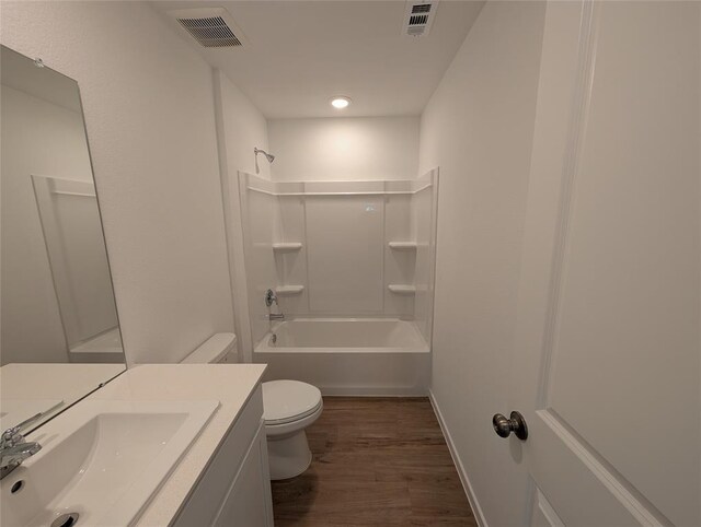 10821 Red Orchid Dr, Houston, TX 77016 - full bathroom with toilet, wood finished floors, shower / tub combination, vanity, and baseboards