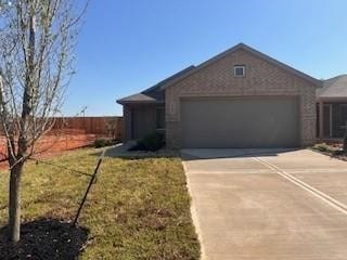 10821 Red Orchid Dr, Houston, TX 77016 - ranch-style house with an attached garage and driveway