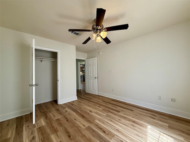 602 E Main St, Kirbyville, TX 75956 - unfurnished bedroom featuring ceiling fan, light wood-style flooring, a closet, and baseboards