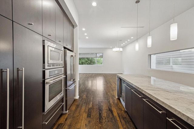 kitchen with decorative light fixtures, recessed lighting, dark wood-style flooring, light stone countertops, and appliances with stainless steel finishes