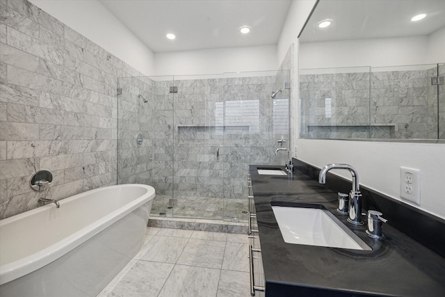 bathroom with a sink, a freestanding bath, double vanity, and a stall shower