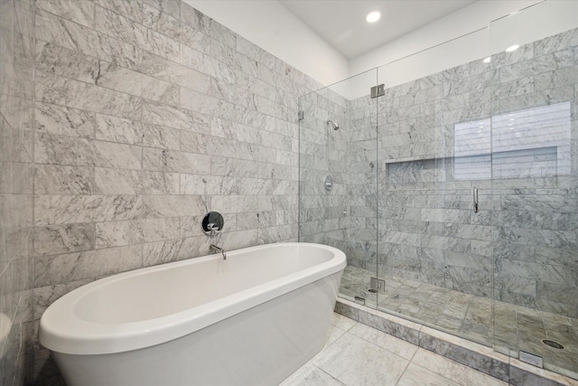 bathroom with a stall shower, tile walls, a soaking tub, and recessed lighting