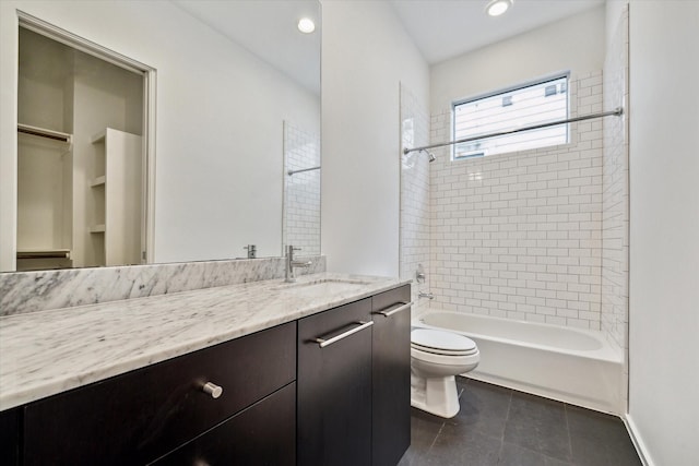 full bathroom featuring toilet, vanity, tile patterned flooring, shower / bath combination, and baseboards