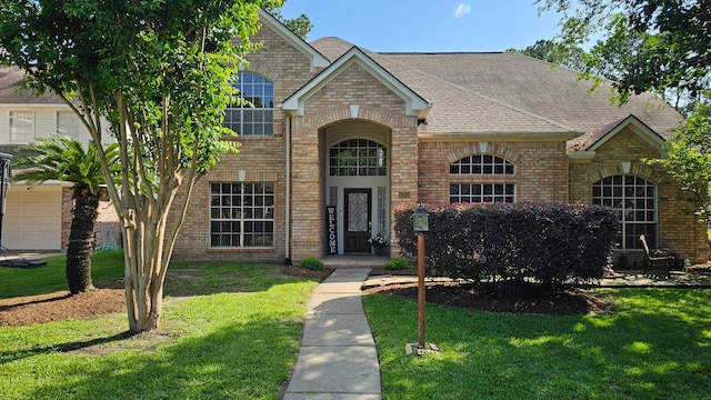 12934 Bristol Berry Dr, Cypress, TX 77429 - view of front facade featuring brick siding, a front lawn, and a shingled roof