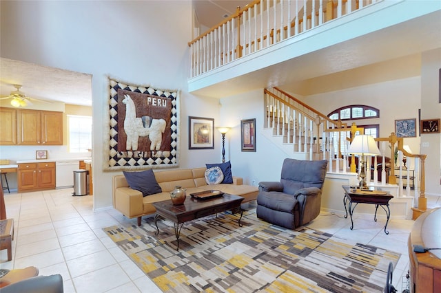 12934 Bristol Berry Dr, Cypress, TX 77429 - living room with a high ceiling, light tile patterned flooring, stairway, and a ceiling fan