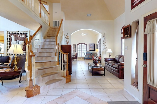 12934 Bristol Berry Dr, Cypress, TX 77429 - entryway with a towering ceiling, arched walkways, tile patterned flooring, and stairs