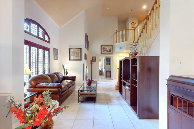 12934 Bristol Berry Dr, Cypress, TX 77429 - living room featuring high vaulted ceiling, light tile patterned flooring, plenty of natural light, and crown molding