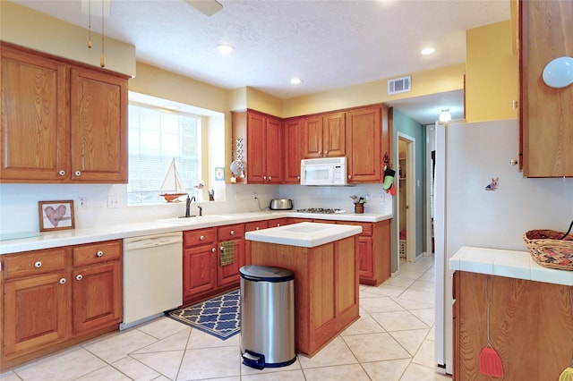 12934 Bristol Berry Dr, Cypress, TX 77429 - kitchen with white appliances, a sink, brown cabinets, recessed lighting, and decorative backsplash