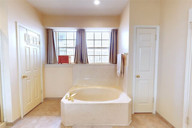 12934 Bristol Berry Dr, Cypress, TX 77429 - full bathroom featuring a garden tub, baseboards, and tile patterned flooring
