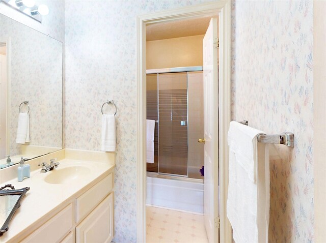 12934 Bristol Berry Dr, Cypress, TX 77429 - full bath with wallpapered walls, vanity, combined bath / shower with glass door, and tile patterned floors