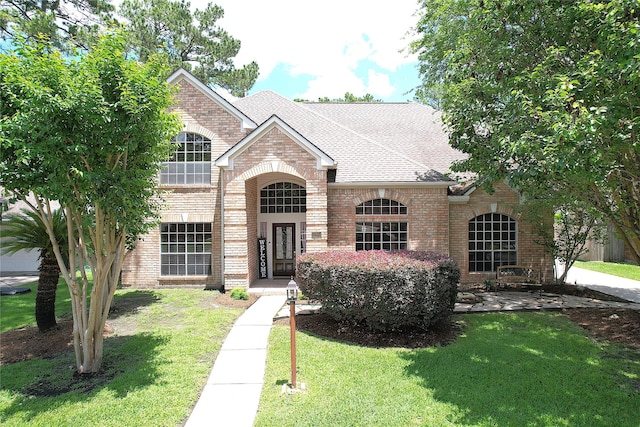 12934 Bristol Berry Dr, Cypress, TX 77429 - french provincial home featuring brick siding, a front yard, and roof with shingles