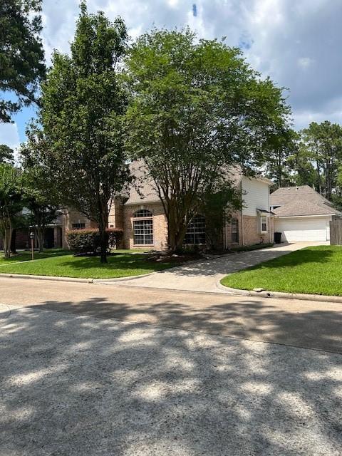 12934 Bristol Berry Dr, Cypress, TX 77429 - view of front of home featuring a front lawn, a garage, driveway, and brick siding