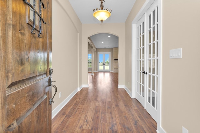 1650 Winding Canyon Ct, Katy, TX 77493 - foyer entrance with arched walkways, baseboards, french doors, and dark wood-style floors