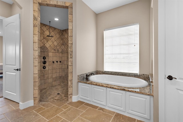 1650 Winding Canyon Ct, Katy, TX 77493 - full bath featuring a walk in shower, baseboards, a bath, and stone tile flooring