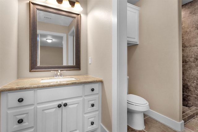 1650 Winding Canyon Ct, Katy, TX 77493 - full bath featuring toilet, vanity, visible vents, baseboards, and a tile shower