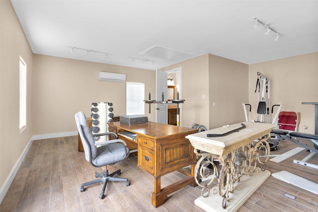1650 Winding Canyon Ct, Katy, TX 77493 - office area featuring light wood-style floors, a wall unit AC, attic access, and track lighting