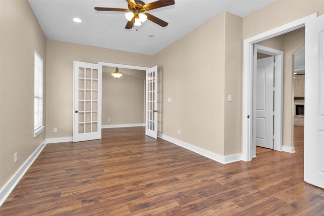 1650 Winding Canyon Ct, Katy, TX 77493 - spare room featuring baseboards, french doors, a ceiling fan, and dark wood-style floors