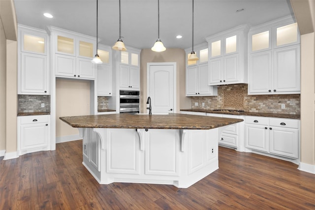 1650 Winding Canyon Ct, Katy, TX 77493 - kitchen featuring dark countertops, tasteful backsplash, and white cabinets
