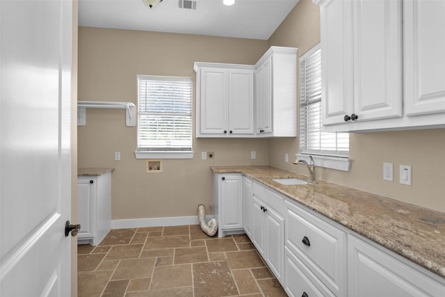 1650 Winding Canyon Ct, Katy, TX 77493 - laundry area featuring baseboards, hookup for a washing machine, a sink, cabinet space, and electric dryer hookup