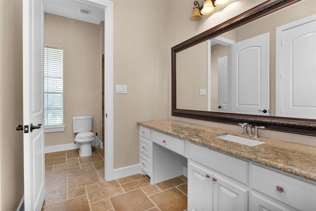 1650 Winding Canyon Ct, Katy, TX 77493 - full bathroom featuring baseboards, vanity, stone tile floors, and plenty of natural light