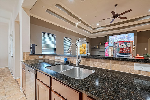 kitchen featuring a raised ceiling, crown molding, a sink, and dishwasher