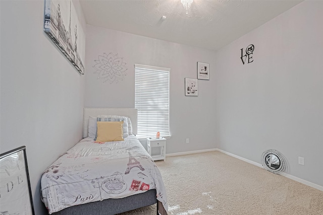 bedroom featuring carpet flooring and baseboards