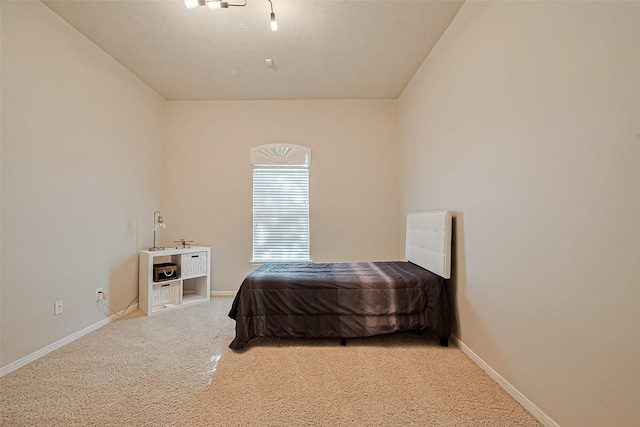 carpeted bedroom featuring baseboards