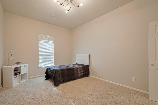 carpeted bedroom featuring baseboards