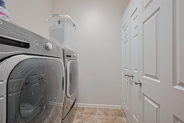 laundry area with washer and dryer, laundry area, and baseboards