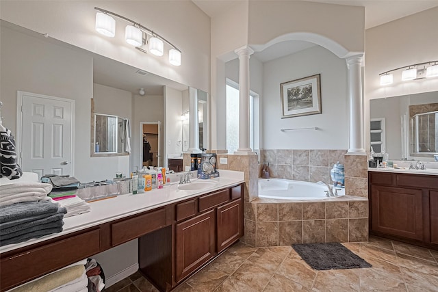 full bathroom with a stall shower, a bath, vanity, and decorative columns