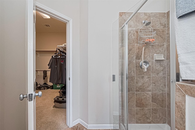 bathroom featuring a stall shower, visible vents, and a walk in closet