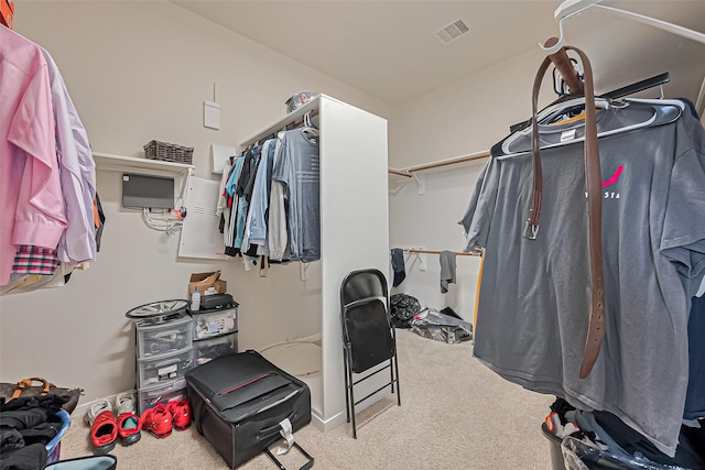 walk in closet featuring visible vents and carpet floors
