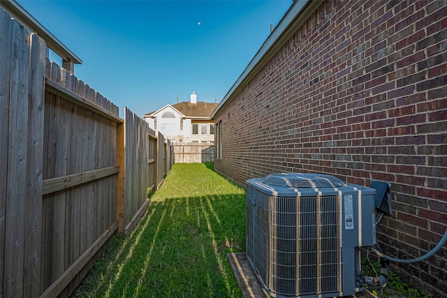 view of yard with cooling unit and a fenced backyard