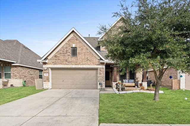 view of front of property featuring concrete driveway, a front yard, brick siding, and a garage
