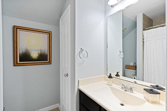 bathroom featuring vanity, toilet, and a shower with shower curtain
