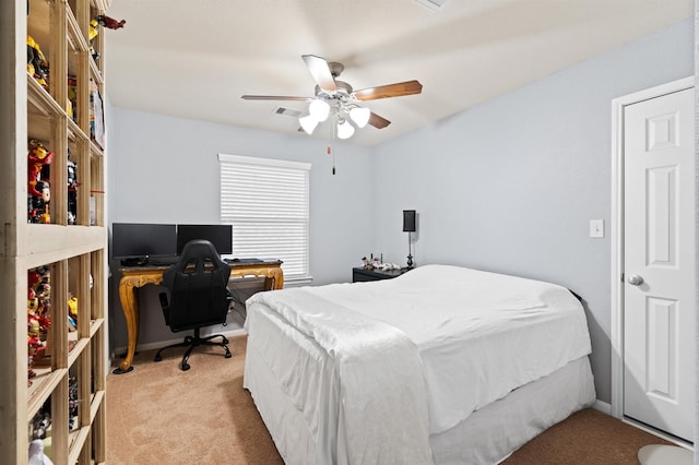 bedroom featuring a ceiling fan, visible vents, and light colored carpet
