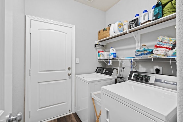 washroom featuring washing machine and dryer, laundry area, and dark wood-style floors