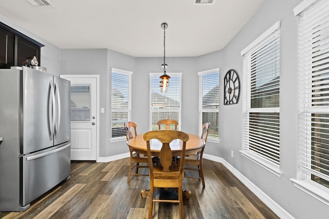 dining space featuring baseboards, dark wood-style floors, and visible vents
