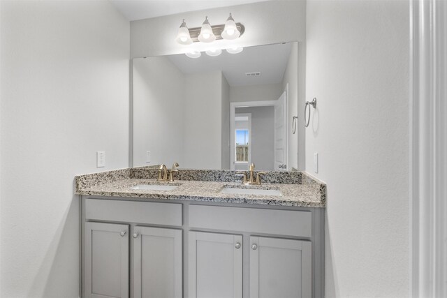 13714 Seneca Lake Dr, Texas City, TX 77568 - bathroom featuring a sink, double vanity, and visible vents