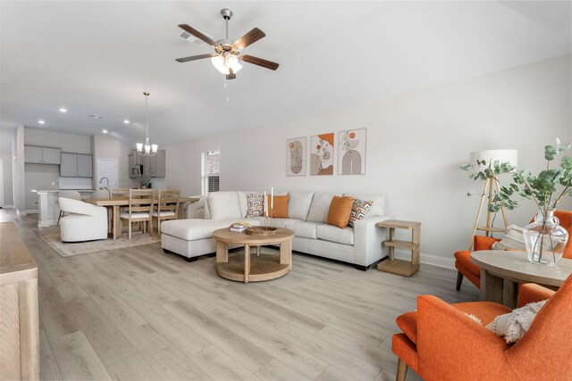 13714 Seneca Lake Dr, Texas City, TX 77568 - living area with lofted ceiling, recessed lighting, baseboards, ceiling fan with notable chandelier, and light wood-style floors