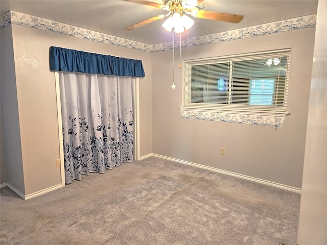 unfurnished room with carpet flooring, baseboards, and ceiling fan