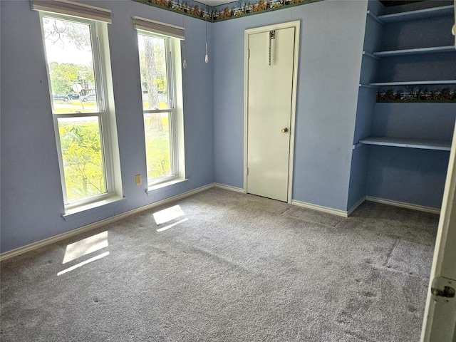 unfurnished bedroom with baseboards and carpet flooring