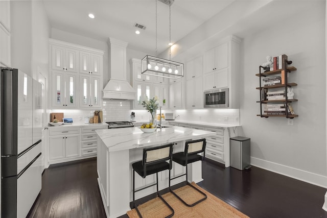 kitchen with white cabinets, appliances with stainless steel finishes, visible vents, and dark wood-style floors
