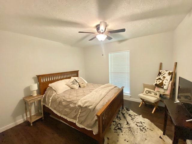 685 W 4th St, Groveton, TX 75845 - bedroom featuring baseboards, ceiling fan, and dark wood-style floors