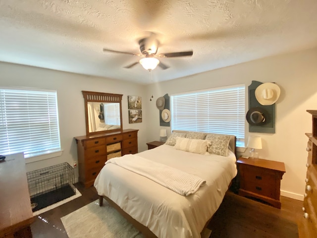 685 W 4th St, Groveton, TX 75845 - bedroom featuring baseboards, a ceiling fan, multiple windows, and wood finished floors