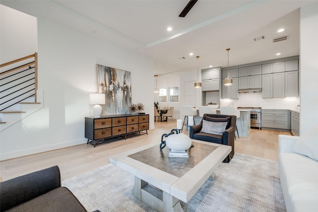 411 W Drew St, Houston, TX 77006 - living room featuring light wood finished floors, stairs, visible vents, and recessed lighting