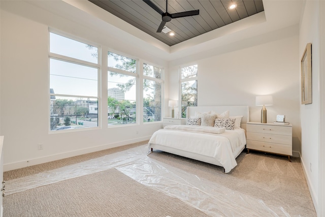 411 W Drew St, Houston, TX 77006 - bedroom featuring a tray ceiling, ceiling fan, light carpet, and baseboards