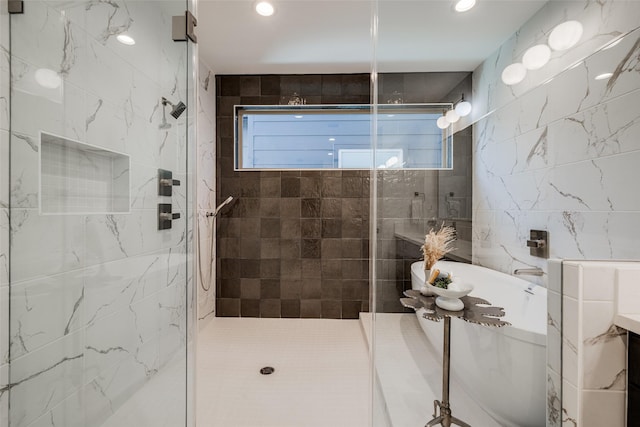411 W Drew St, Houston, TX 77006 - bathroom featuring a stall shower, tile walls, and recessed lighting