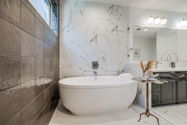 411 W Drew St, Houston, TX 77006 - bathroom with a freestanding bath, tile walls, and vanity