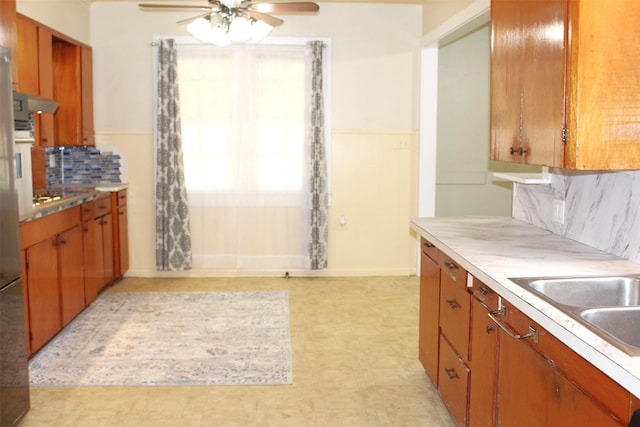508 Texas St, Brenham, TX 77833 - kitchen featuring light countertops, baseboards, tasteful backsplash, and a ceiling fan